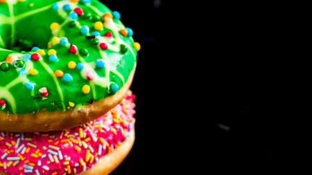 Glazed donuts with sprinkles isolated. Close up of colorful donuts.の写真素材