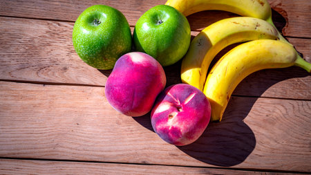 Mix of fruits on wooden table. Banana, apple, nectarineの写真素材