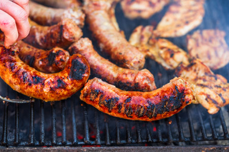 Grilling sausages and pork chops on barbecue grill. BBQ in the gardenの写真素材