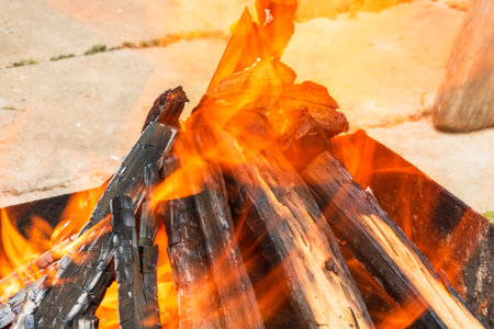 Burning wood chips forming coal. Barbecue preparation, fire before cooking. Hot coal made of greatly heated wood.の写真素材