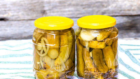 Glass jar with pickles isolated. Preserved food concept, canned vegetables isolated in a rustic composition.の写真素材