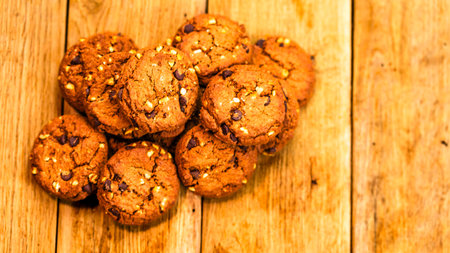 Biscuits on wooden table. Chocolate cookies on the table, breakfast concept. Top view with copy spaceの写真素材