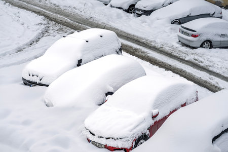 Snow on cars after snowfall. Winter urban scene and snow-covered carsの写真素材