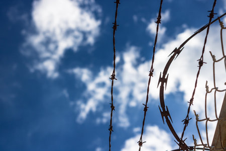 Barbed wire protection fence. Concept photo for security and lack of freedom backgroundの写真素材