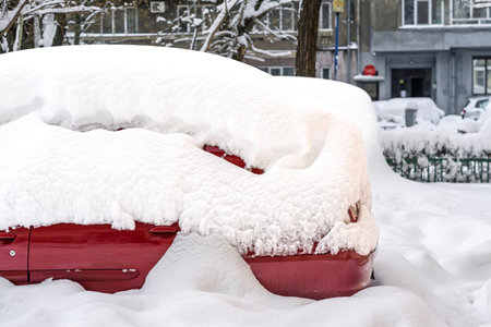Snow on cars after snowfall. Winter urban scene and snow-covered carsの写真素材