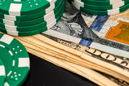 Stacks of poker chips with money on black background, US Dollar currencyの写真素材
