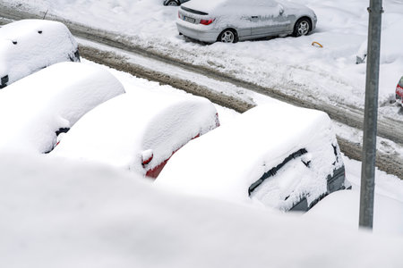 Snow on cars after snowfall. Winter urban scene and snow-covered carsの写真素材