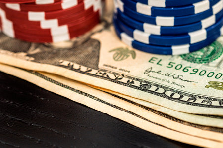 Stacks of poker chips with money on black background, US Dollar currency