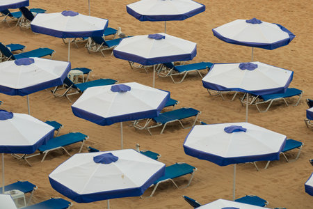 Beach deckchairs with umbrellas at tropical relax beachの写真素材