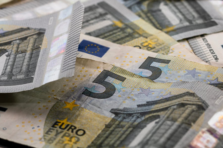 5 EURO banknotes. EUR money background representing savings, income, or investment