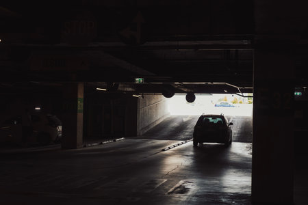 Empty underground garage. Empty parking lot with overhead dim light