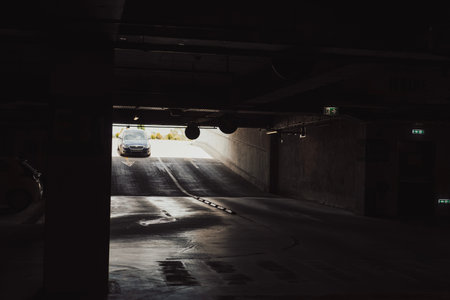 Empty underground garage. Empty parking lot with overhead dim light