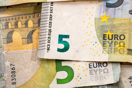 5 EURO banknotes. EUR money background representing savings, income, or investment