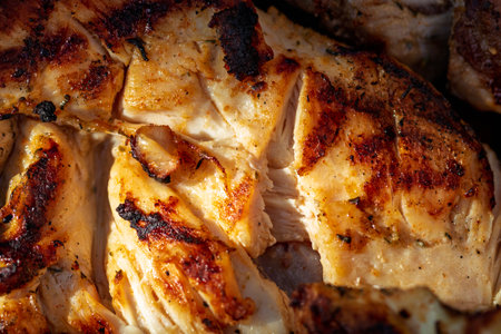 Pork chops, steak, sausages on barbecue grill with smokeの写真素材