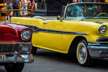 Vintage classic American car in Havana, Cuba. Typical Havana urban scene with colorful buildings and...