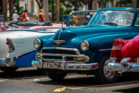 Vintage classic American car in Havana, Cuba. Typical Havana urban scene with colorful buildings and...