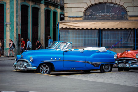 Vintage classic American car in Havana, Cuba. Typical Havana urban scene with colorful buildings and old carsの写真素材