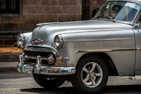 Vintage classic American car in Havana, Cuba. Typical Havana urban scene with colorful buildings and...