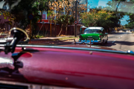 Vintage classic American car in Havana, Cuba. Typical Havana urban scene with colorful buildings and...