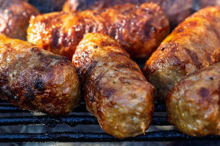Pork chops, steak, sausages on barbecue grill with smoke