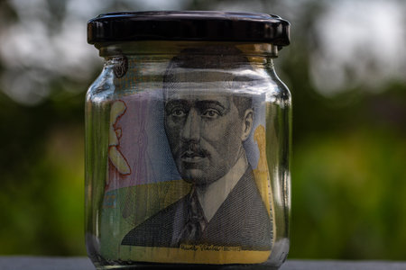 Romanian LEI banknote saving money in glass jar. Consumption and economy. Business, tips, finance,...
