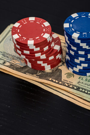 Stacks of poker chips with money on black background, US Dollar currency