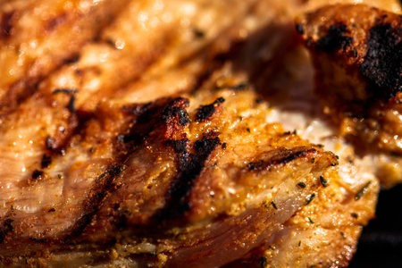 Pork chops, steak, sausages on barbecue grill with smokeの写真素材