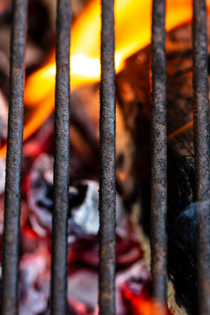 BBQ grill with burning wood and fire flames. Empty hot charcoal barbecue grill with bright flame