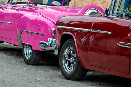 Vintage classic American car in Havana, Cuba. Typical Havana urban scene with colorful buildings and...