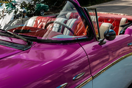 Vintage classic American car in Havana, Cuba. Typical Havana urban scene with colorful buildings and...