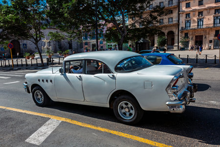 Vintage classic American car in Havana, Cuba. Typical Havana urban scene with colorful buildings and...