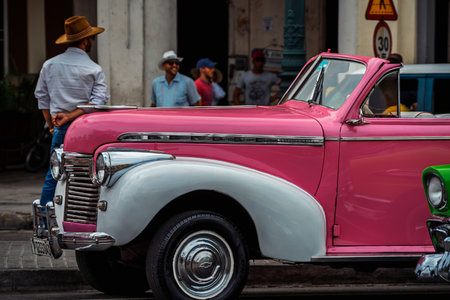 Vintage classic American car in Havana, Cuba. Typical Havana urban scene with colorful buildings and old carsの写真素材