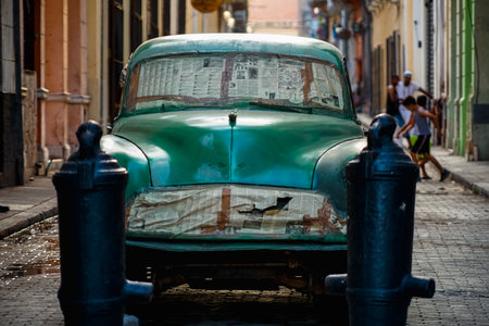 Vintage classic American car in Havana, Cuba. Typical Havana urban scene with colorful buildings and old carsの写真素材