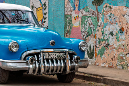 Vintage classic American car in Havana, Cuba. Typical Havana urban scene with colorful buildings and old carsの写真素材