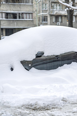 Snow on cars after snowfall. Winter urban scene and snow-covered carsの写真素材