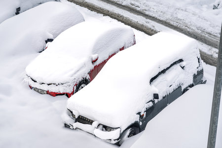 Snow on cars after snowfall. Winter urban scene and snow-covered carsの写真素材