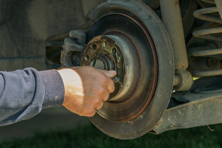 Car Wheel Maintenance by Mechanic Using Wrench at Garageの写真素材
