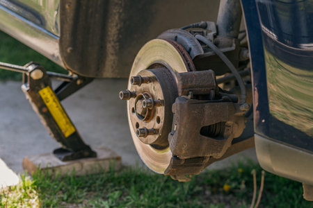 Car Wheel Maintenance by Mechanic Using Wrench at Garageの写真素材