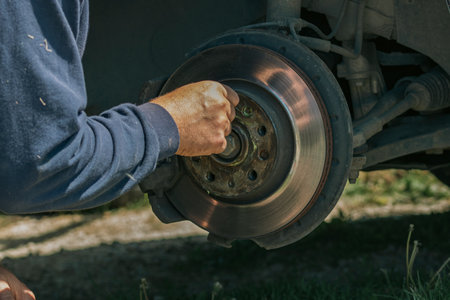 Car Wheel Maintenance by Mechanic Using Wrench at Garageの写真素材