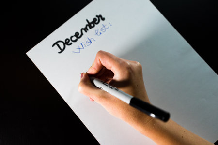 Hand Writing Goals or Gift List on White Sheet â Planning, Motivation and Holiday Preparationの写真素材