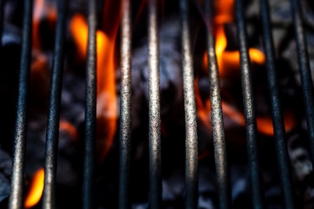 BBQ grill with burning wood and fire flames. Empty hot charcoal barbecue grill with bright flameの写真素材