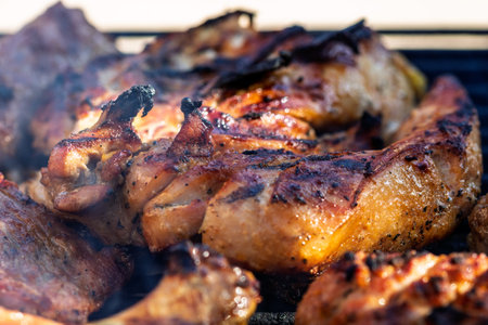 Pork chops, steak, sausages on barbecue grill with smoke