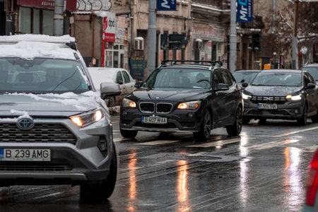 Morning traffic congestion with cars on snowy roads in Bucharest Romania during winter