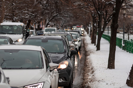 Morning traffic congestion with cars on snowy roads in Bucharest Romania during winterのeditorial素材