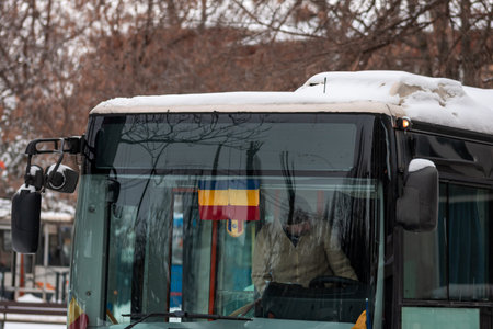 Winter morning commute with public transport STB vehicle on snowy roads in Bucharest Romaniaのeditorial素材