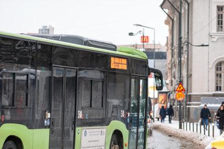 Winter morning commute with public transport STB vehicle on snowy roads in Bucharest Romaniaのeditorial素材