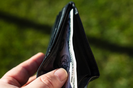 Man hand holding a wallet showing paper texture and symbols