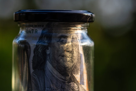 US dollar banknote saving money in glass jar. Consumption and economy. Business, tips, finance,...