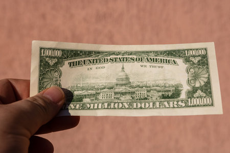 Man hand holding 1 Million dollar banknote, showing paper texture and symbol of American Dream