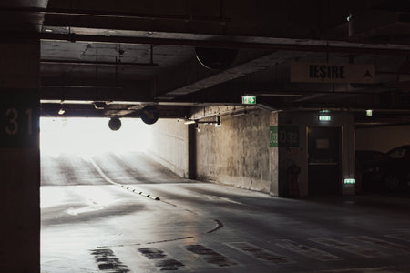Empty underground garage. Empty parking lot with overhead dim lightの写真素材